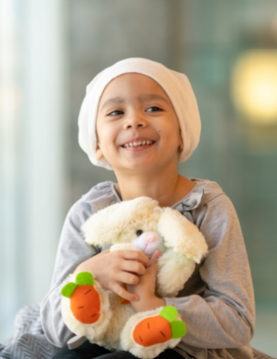 young child holding stuffed bunny