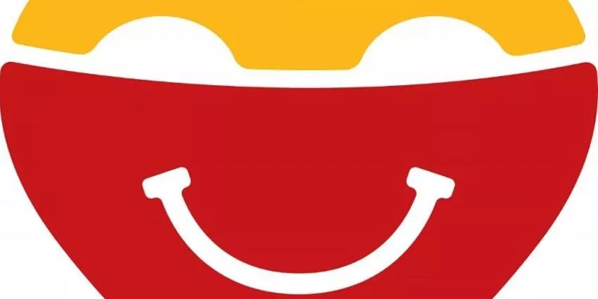 Red bowl with white content and yellow layer, featuring a white smile-shaped line on it