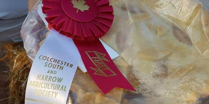Packaged baked apple pie with first-place and Colchester South and Narrow Agricultural Society ribbons.