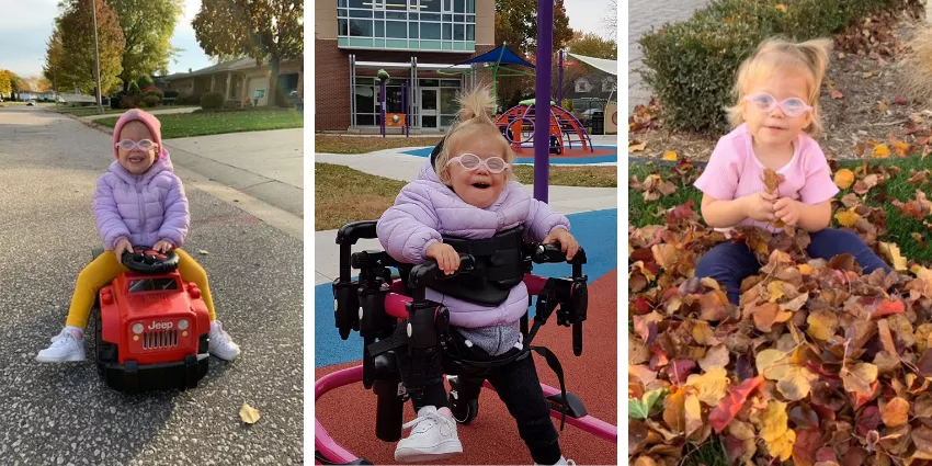 Young girl with glasses playing on toy Jeep, using mobility aid, and sitting in autumn leaves.