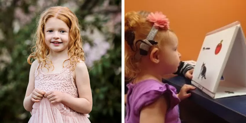 Two young girls, one outdoors in a pink dress, the other with a cochlear implant using a picture card.