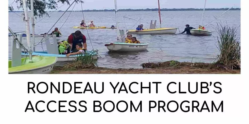 Small sailboats with people on water near shore in Rondeau Yacht Club Access Boom Program.