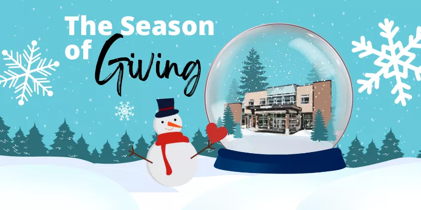 Winter scene with snowman beside a snow globe containing a building, trees, and seasonal text.