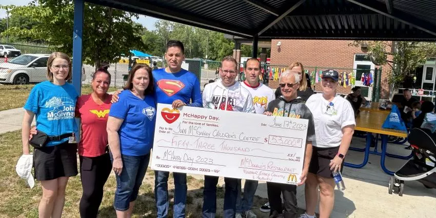 Group outdoors holding $53,000 check for John McGivney Children's Centre dated June 17, 2023.