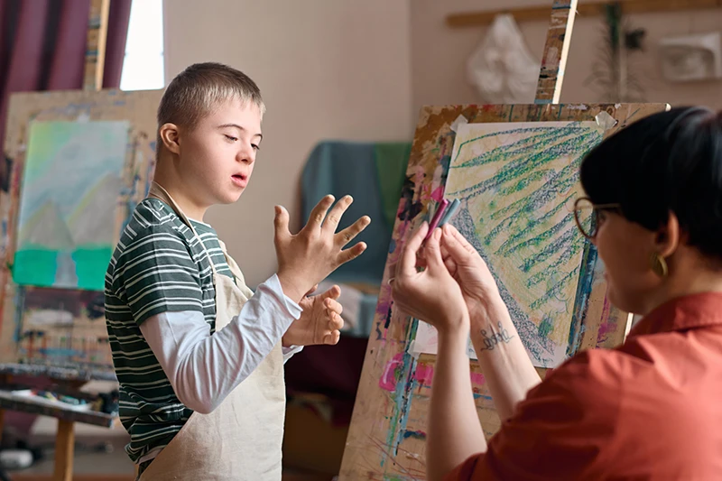 Boy with Down Syndrome choosing paint colours