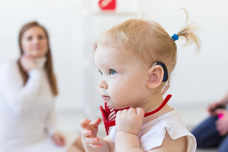 Toddler wearing hearing aid