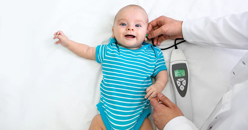 Baby having hearing screening